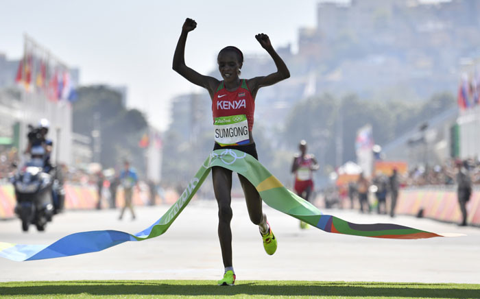 FILE: Kenya's Jemima Jelagat Sumgong raises her arms in victory as she crosses the finish line of the Women's Marathon during the athletics event at the Rio 2016 Olympic Games at Sambodromo in Rio de Janeiro on 14 August, 2016. Picture: AFP.