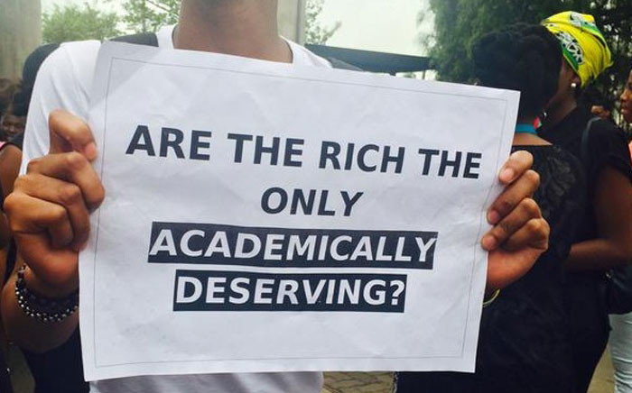 A student holds a placard at the student protest on 14 October 2015 after Wits University proposed an increase of 10.5 percent in tuition fees for 2016. Picture: @Zoe_Ngwenyurr via Twitter.