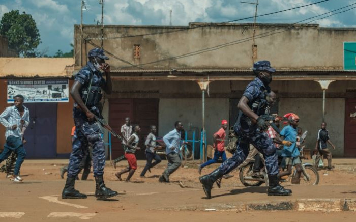 FILE: Uganda police disperse crowds in Kayunga town as they gather to welcome Ugandan musician-turned-politician Robert Kyagulanyi, also known as Bobi Wine, on 1 December 2020. Picture: AFP.