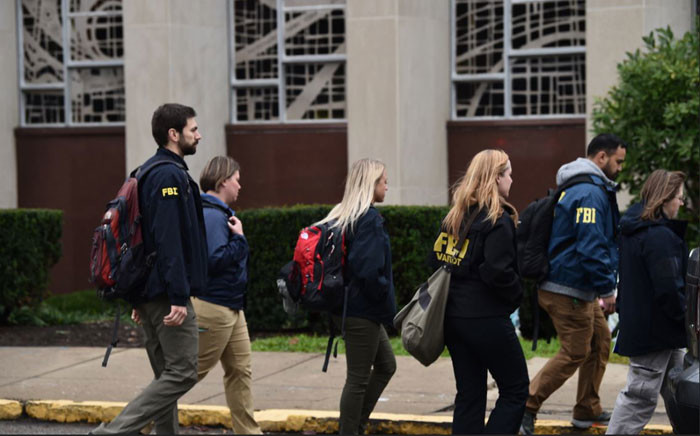 Members of the FBI and others gather on 28 October 2018 outside of the Tree of Life Synagogue after a shooting there left 11 people dead in the Squirrel Hill neighbourhood of Pittsburgh on 27 October 2018. Picture: AFP
