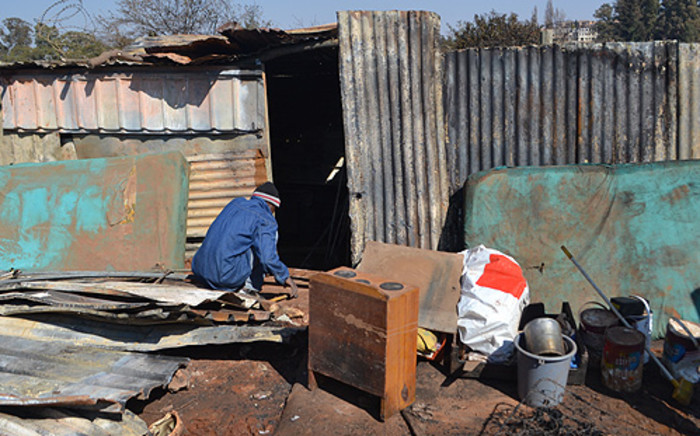 FILE: A man builds a shacks. Picture: EWN