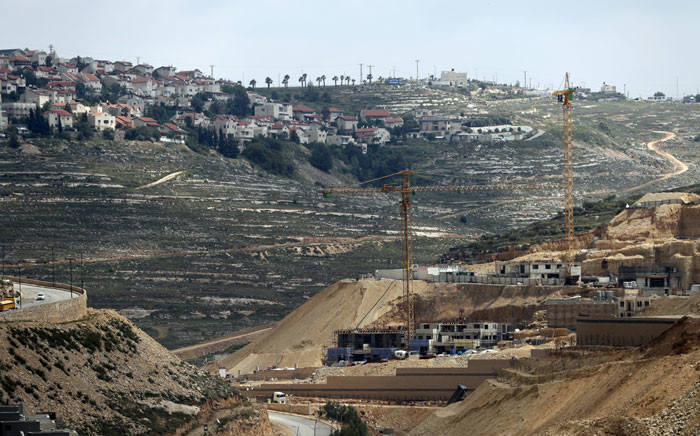 FILE: Workers and bulldozers work at a construction site in the Israeli settlement of Givat Zeev near the West Bank city of Ramallah. Picture: AFP.