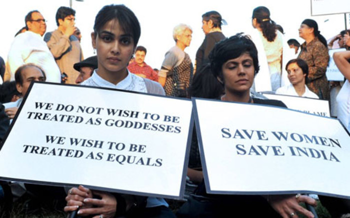 Indian Bollywood actresses Genelia D'Souza (L) and Mandira Bedi take part in a candlelight vigil in Mumbai on 29 December 2012, after the death of a gang rape victim from New Delhi. Picture: AFP
