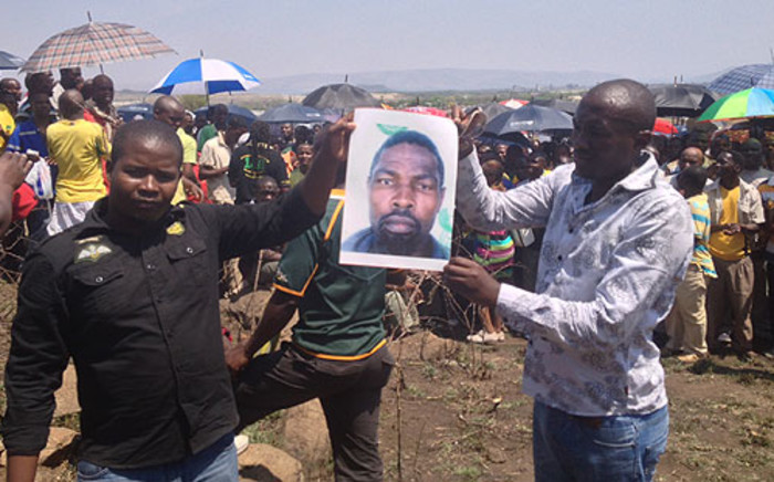 Amplats miners hold up a picture of their comrade who was killed who was killed allegedly by police on 4 October 2012. Picture:Govan Whittles/EWN 