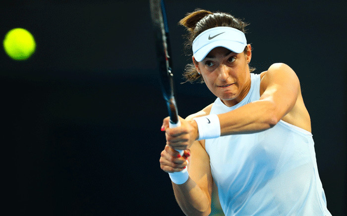 Caroline Garcia of France hits a return to compatriot Alize Cornet during their first round women's singles match at the Brisbane International tennis tournament at the Pat Rafter Arena in Brisbane on 31 December 2017. Picture: AFP.