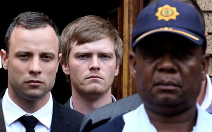 Murder accused Oscar Pistorius is escorted out of the High Court in Pretoria on day 10 of his murder trial. Picture: Sebabatso Mosamo/EWN.