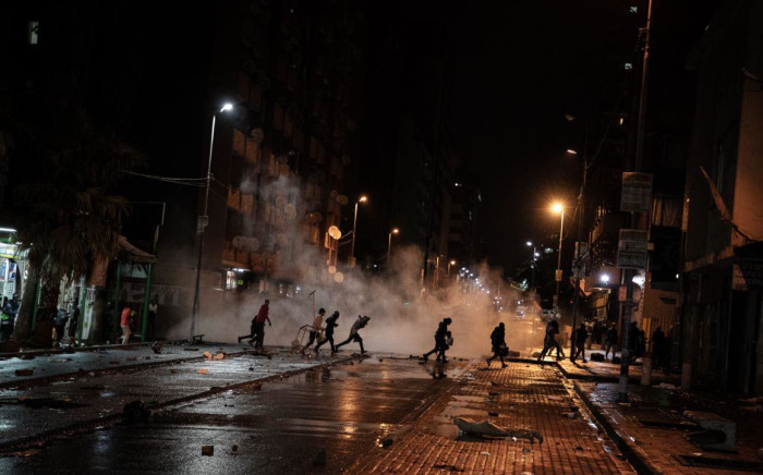 People fleeing as police use water cannons and rubber bullets to disperse them from the streets of Hillbrow, in what was believed to be a #FreeZuma protest on 11 July 2021. Picture: Boikhutso  Ntsoko/ Eyewitness News.