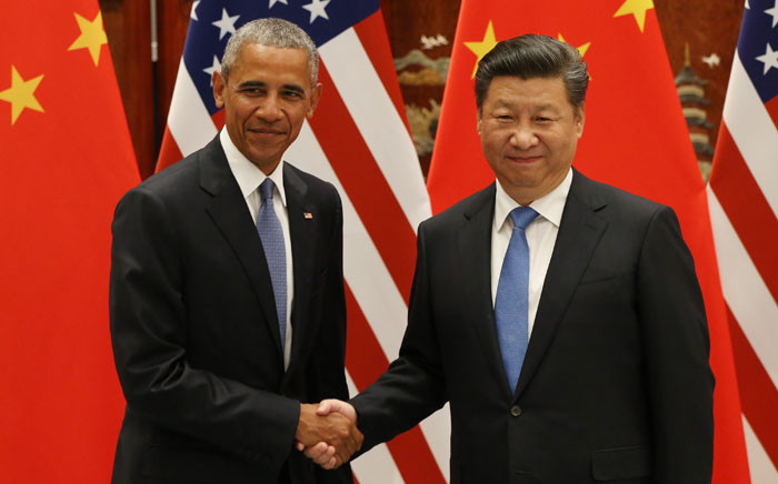 FILE: Former US President Barack Obama (L) and Chinese President Xi Jinping shake hands during a meeting at the West Lake State Guest House in Hangzhou on 3 September 2016, where the United States and China formally joined the Paris climate deal. Picture: AFP