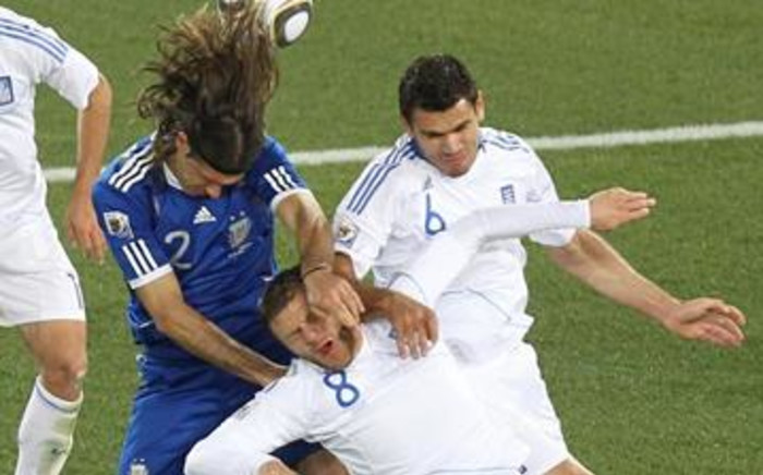 Heads, I win: Argentine defender Martin Demichelis (blue shirt) wins a header against two Greek players during a 2010 World Cup match in Polokwane. Picture: AFP