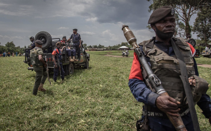 A soldier of the Democratic Republic of Congo's armed forces holds his weapon during a security patrol around the Kiwanja airfield days after clashes with the M23 rebels in Rutshuru on 3 April 2022.