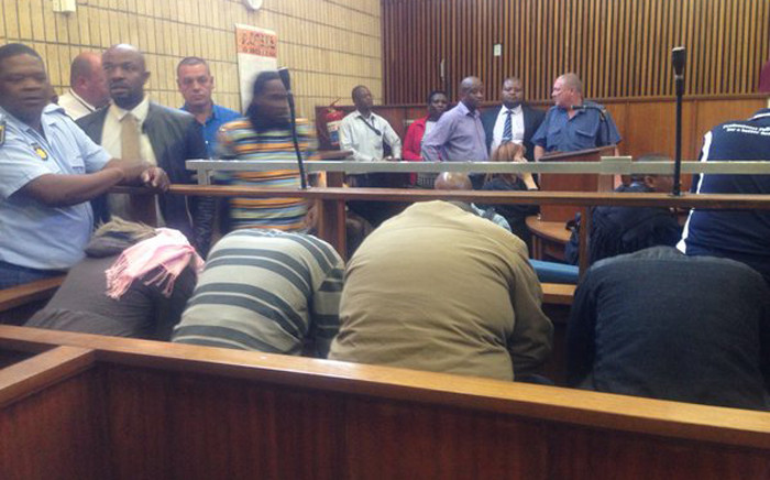 FILE: Four police officers accused of the murder of 32-year-old Khulekani Mpanza hide their faces in the Krugersdorp Magistrates Court on 3 November 2015. Picture: Mia Lindeque/EWN.