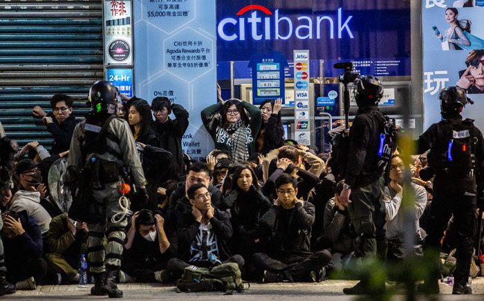 FILE: Police detain a group of people after a pro-democracy march in Hong Kong on 1 January 2020.. Picture: AFP
