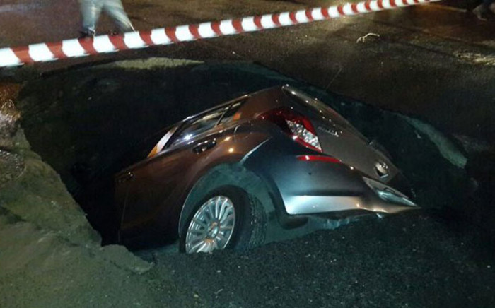 A woman narrowly escaped death when her car became engulfed by a sinkhole in Low Road, Wetton on 1 November 2014. Picture: Ayesha Parker