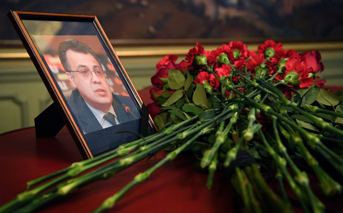 Flowers are placed in front of a portrait of Andrey Karlov in the Foreign Ministry in Moscow on 20 December, 2016, a day after the assassination of the Russian ambassador in the Turkish capital. Picture: AFP.