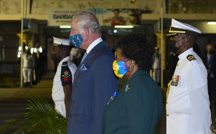 His Royal Highness Prince Charles, Prince of Wales (L) and president-elect Dame Sandra Mason (2L) stand at attention as the national anthem plays at Grantley Adams International Airport in Christchurch, Barbados, on 28 November 2021. Picture: Randy Brooks/AFP