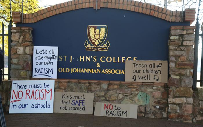 Posters outside St John's College in Johannesburg after a racist teacher was allowed to keep his job on 28 July 2017. Picture: Christa Eybers/EWN