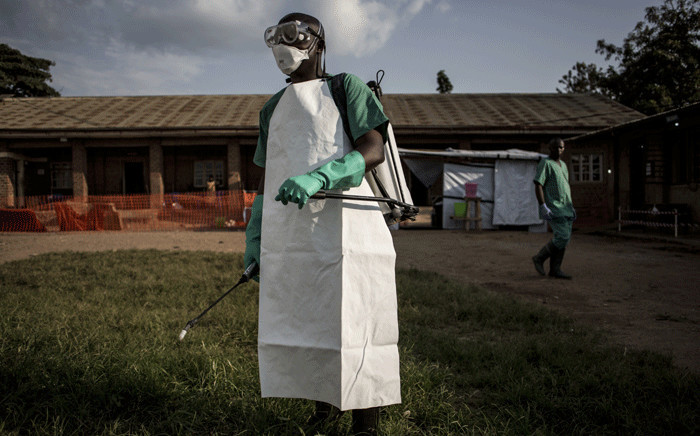 FILE: A hygienist is seen inside an Ebola Treatment Centre run by The Alliance for International Medical Action (ALIMA) on 12 August 2018, in Beni. Picture: AFP