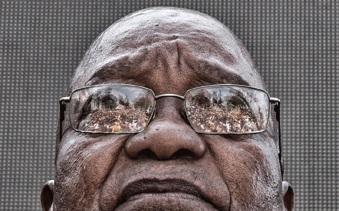 The crowd who gathered to support former President Jacob Zuma is seen reflected in his glasses as he waits to speak after appearing on corruption charges at the Durban High Court on 6 April 2018. Picture: Ihsaan Haffejee/Eyewitness News.