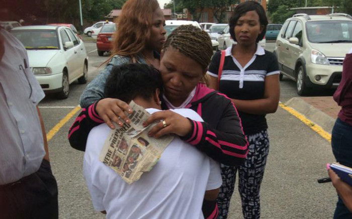Three-year-old Cuburne van Wyk’s mother Lezell being comforted outside court following another postponement in his murder case on 17 December 2014. Picture: Thando Kubheka/EWN.