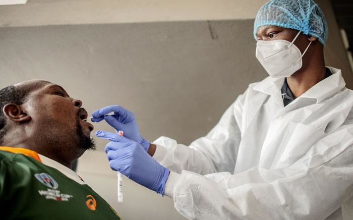 FILE: A nurse from Lancet Nectare hospital performs a COVID-19 coronavirus test in Richmond, Johannesburg, on 18 December 2020. Picture: AFP.