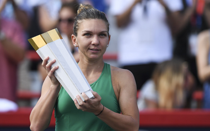 Simona Halep of Romania holds up the trophy during the post-game ceremony after defeating Sloane Stephens 7-6, 3-6, 6-4 in the final on day seven of the Rogers Cup at IGA Stadium on 12 August 2018 in Montreal, Quebec, Canada. Picture: AFP