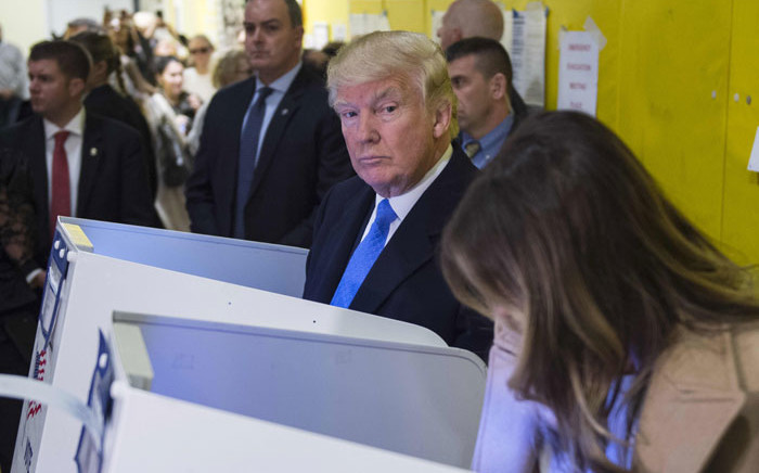 Republican presidential nominee Donald Trump and his wife Melania fill out their ballots at a polling station in a school during the 2016 presidential elections on November 8, 2016 in New York. Picture: AFP