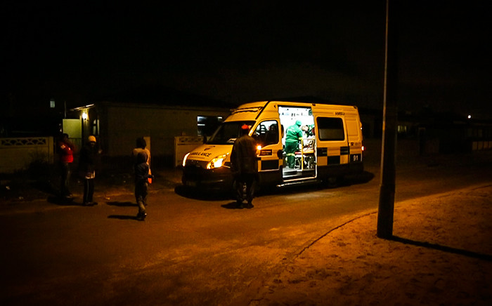 A Metro EMS ambulance is parked outside a patient's house while the man is being treated. Picture: Anthony Molyneaux/EWN