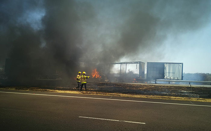 Firefighters attending the blaze at the scene of a multi-vehicle pile-up on the N1 between the Petroport and Walmansthal. Picture: @_ArriveAlive/Twitter