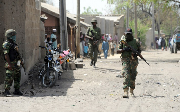 FILE: Nigerian soldiers walking in the street in the remote northeast town of Baga, Borno State. Picture: AFP
