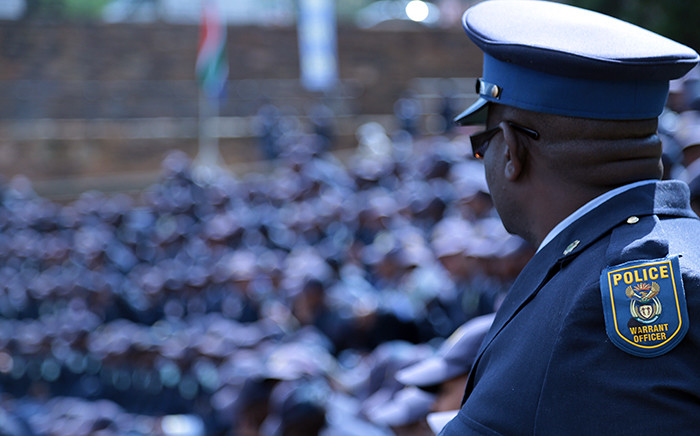 A police officer looks on into the crowd at the commemoration ceremony at the Union Buildings in Pretoria for the almost 60 police officers killed since the start of 2015. Picture: Reinart Toerien/EWN.