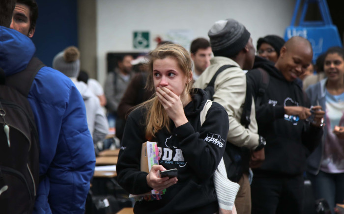 An accounting student stands in disbelief after protesting students disrupt her final year accounting exam. Photo: Bertram Malgas/EWN