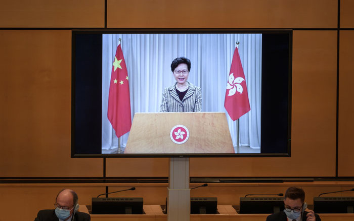 Hong Kong's chief executive Carrie Lam is seen on a giant screen remotely addressing the opening of the UN Human Rights Council's 44th session on 30 June 2020 in Geneva. Picture: AFP