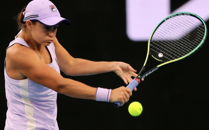 Australia's Ashleigh Barty hits a return against Russia's Ekaterina Alexandrova during their women's singles match on day six of the Australian Open tennis tournament in Melbourne on 13 February 2021. Picture: Brandon MALONE / AFP