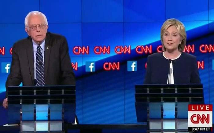 Democratic presidential candidate US Senator Bernie Sanders listens as former Secretary of State Hillary Clinton speaks during the first official Democratic candidates debate of the 2016 presidential campaign in Las Vegas, Nevada on 13 October, 2015. Picture: Screengrab/CNN.