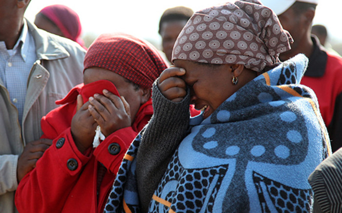 FILE: Family members mourn at a memorial service for the Marikana miners who were killed in a shootout with police on 16 August 2012. Picture: EWN.