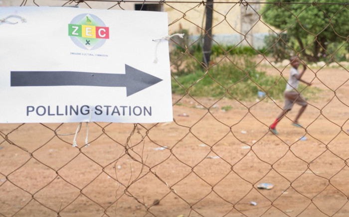 A boys plays with a kite near a polling station on 26 March 2022 in Amaveni township, Zimbabwe. Picture: Zinyange Auntony/AFP