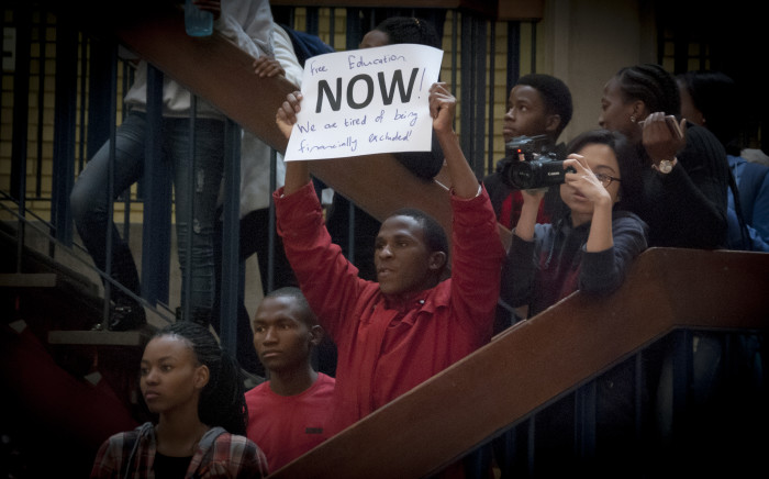 FILE: A students holds up a poster at Wits University after the announcement of an 8% increase by Min of Higher Education Nzimande. Picture: Nina Leslie/EWN