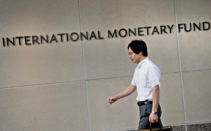 A man walks past the headquarters of the International Monetary Fund (IMF) on 30 June 2015 in Washington, DC. Picture: AFP.