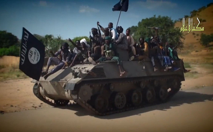 FILE: A screengrab taken on 9 November , 2014, from a new Boko Haram video released by the Nigerian Islamist extremist group Boko Haram and obtained by AFP shows Boko Haram fighters parading on a tank in an unidentified town. Picture: AFP.