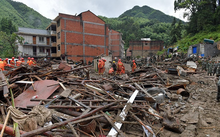 Rescuers look for survivors in the rubble of damaged buildings after a landslide caused by torrential rain from Typhoon Lekima, at Yongjia, in Wenzhou, in China's eastern Zhejiang province on 10 August 2019. Picture: AFP