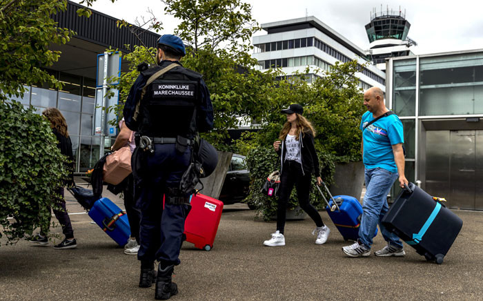 Netherland's military police carry out additional patrols as passengers arrive to Schiphol Airport in Amsterdam on July 30, 2016. Security was stepped up in and around Amsterdam's Schiphol airport on July 30 following a threat, local authorities said in a statement, adding that aviation was unaffected. Picture:  AFP.