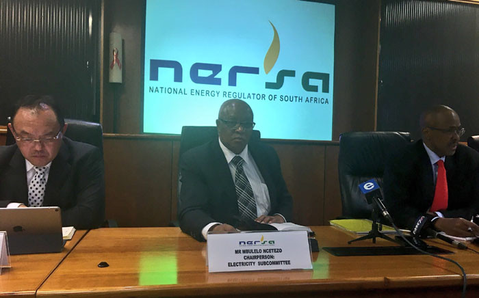 Nersa’s chairperson of the electricity subcommittee Mbulelo Ncetezo (C) addressing the media in Pretoria. Picture: Katleho Sekhotho/EWN