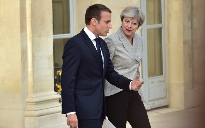 FILE: Britain's Prime Minister Theresa May and France’s President Emmanuel Macron following a meeting to give a joint press conference in the grounds of The Elysee Palace in Paris on 13 June 2017. Picture: AFP.
