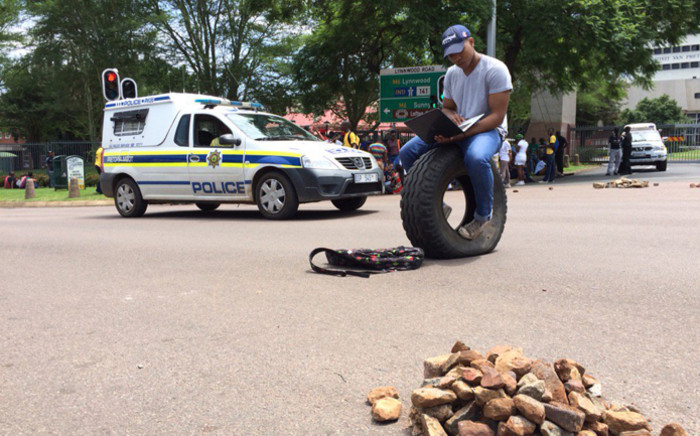 Demonstrating students and the police have clashed at the University of Pretoria’s main entrance, where several students have also been arrested on 19 February 2016. Picture: Barry Bateman/EWN. 