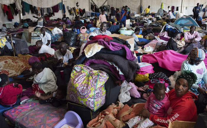 FILE: One part of a group of about 630 people, refugees originally from Democratic Republic of Congo, Rwanda, Burundi, and Bangladesh, and other countries who are sleeping in a large tent in Bellville, Cape Town, on 22 September 2020. Picture: AFP