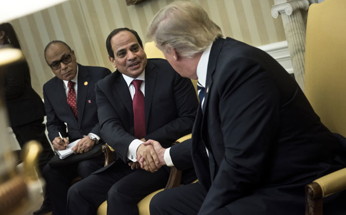 Egypt's President Abdel Fattah al-Sisi (C) and US President Donald Trump (R) shake hands in the Oval Office before a meeting at the White House April 3, 2017 in Washington, DC. Picture: AFP