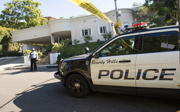 Yellow police tape blocks access to the 1,100 block of Maytor Place where Jacqueline Avant's house is at the top of the hill, in Beverly Hills, California on 1 December 2021. Avant died after being shot by a burglar, who also opened fire on a security guard, according to tabloid website TMZ. Picture: VALERIE MACON/AFP