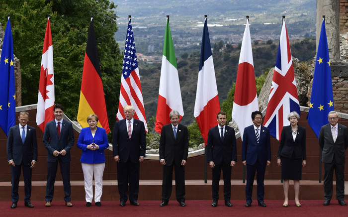 From left : President of the European Council Donald Tusk, Canadian Prime Minister Justin Trudeau, German Chancellor Angela Merkel, US President Donald Trump, Italian Prime Minister Paolo Gentiloni, French President Emmanuel Macron, Japanese Prime Minister Shinzo Abe, Britain's Prime Minister Theresa May and President of the European Commission Jean-Claude Juncker pose for a family photo during the Summit of the Heads of State and of Government of the G7 plus the European Union, on 26 May 2017 in Taormina, Sicily. Picture: AFP.
