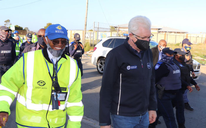 Western Cape Premier Alan Winde (centre) on a patrol with local law enforcement, neighbourhood watch members and SAPS in Delft on 13 October 2020. Picture: @alanwinde/Twitter