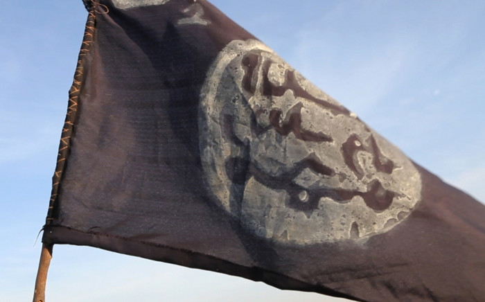 A Boko Haram flag flutters from an abandoned command post in Chad. Picture: AFP.